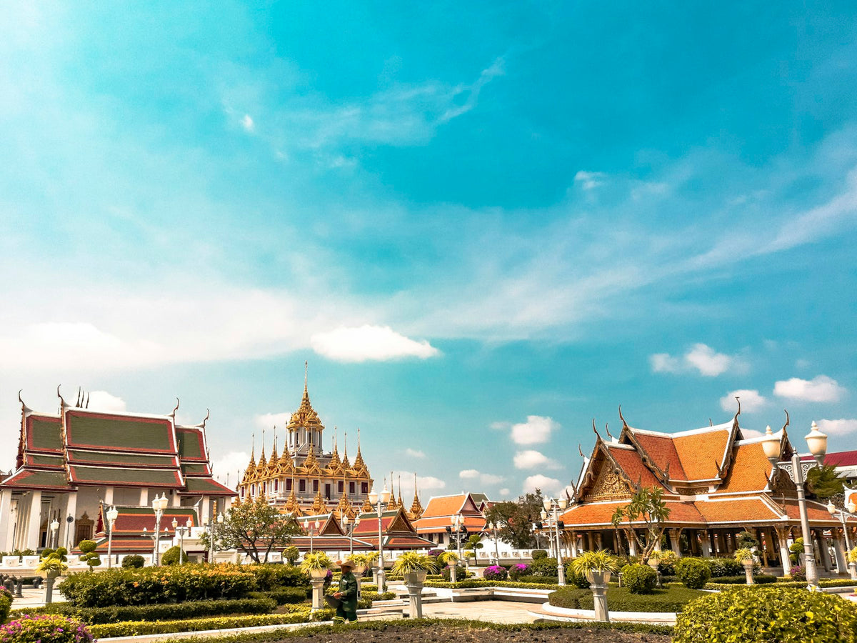 Orange roofs and spires of Loha Prasat temple in Bangkok, Thailand, on a sunny day
